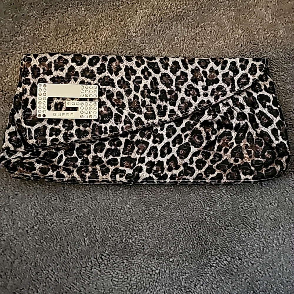 GUESS clutch bag. Animal print w/hearts on inside lining.